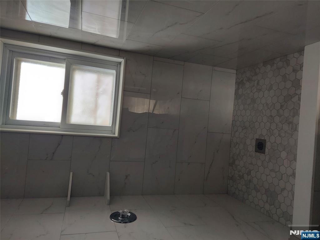 64 East Madison Avenue, Unit #2 Dumont, NJ 07628 - Photo 8 of 14 a bathroom with a window