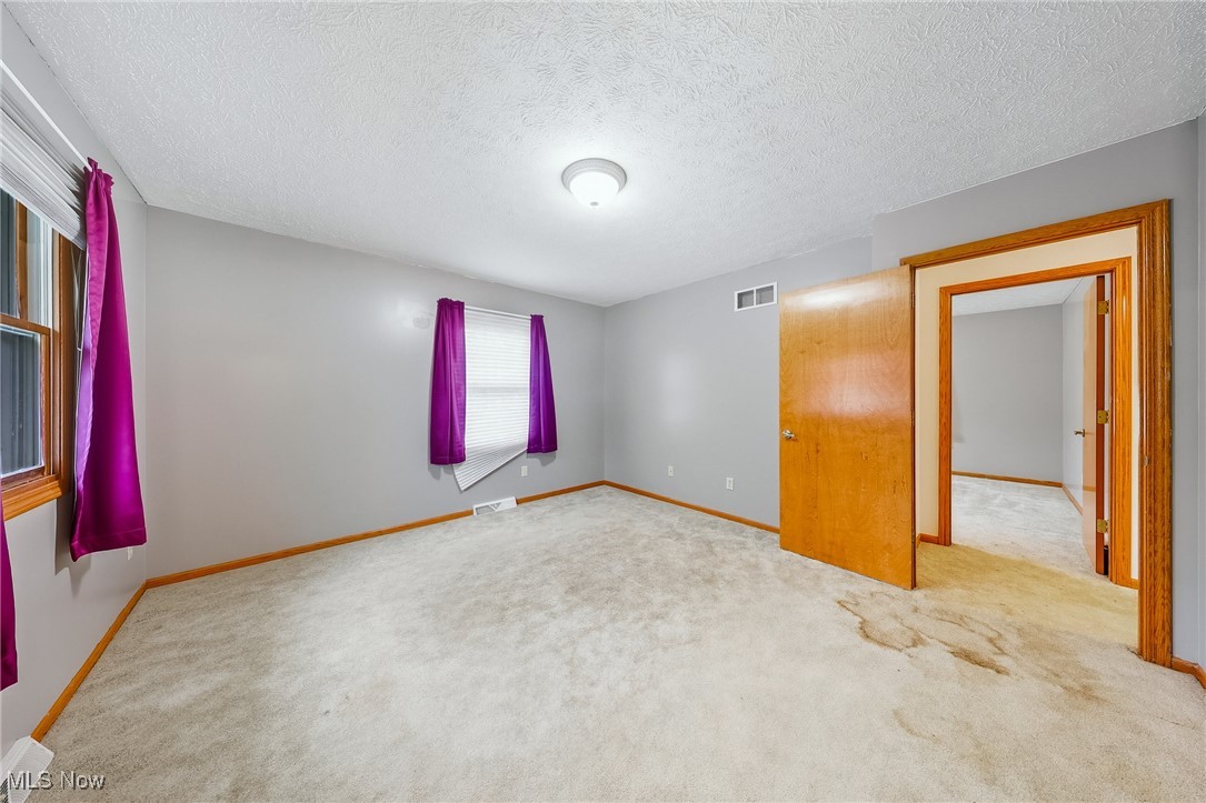 425 Overlook Drive Rittman, OH 44270 - Photo 12 of 44 Unfurnished bedroom with carpet and a textured ceiling