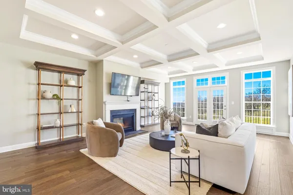 a view of a patio with couches chairs and wooden floor