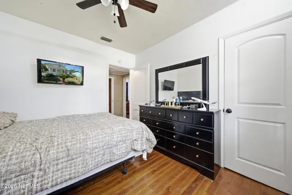 a bedroom with a bed and a dresser
