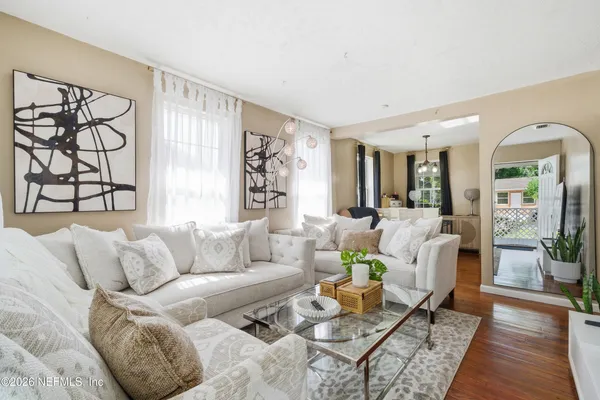 a living room with furniture and wooden floor
