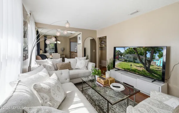 a living room with furniture and a flat screen tv
