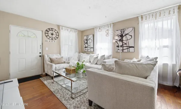 a living room with furniture and a large window
