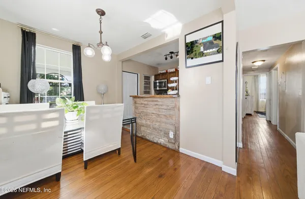 a view of a hallway with wooden floor windows and livingroom view
