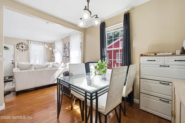 a kitchen with a table chairs refrigerator and cabinets