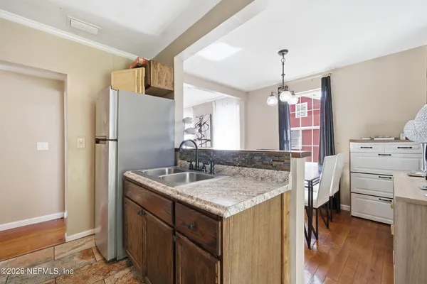 a kitchen with a sink stove and refrigerator