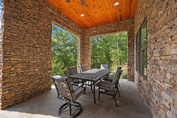 a view of a patio with a table and chairs