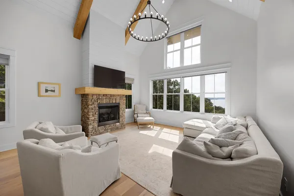 a living room with furniture fireplace and window