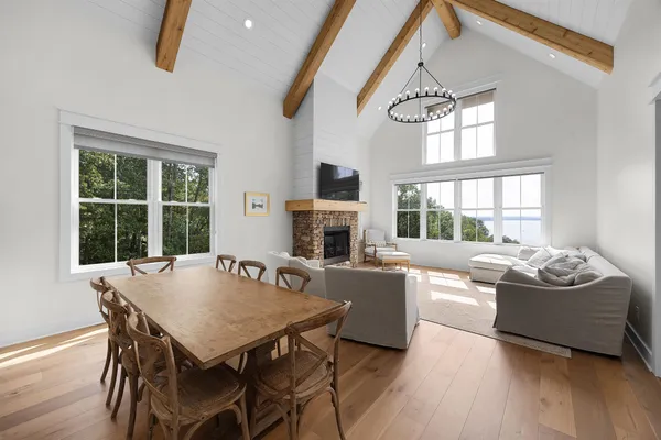 a living room with furniture a fireplace and a floor to ceiling window