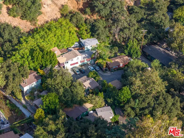 an aerial view of a house with a yard