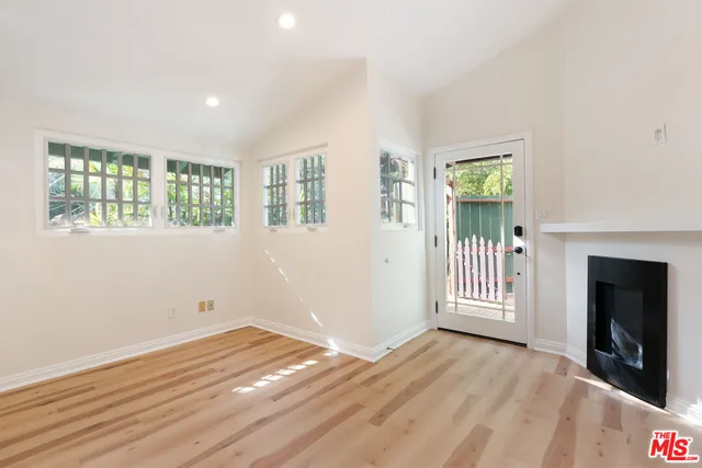 a view of empty room with wooden floor