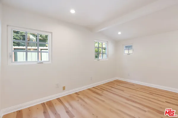 a view of a livingroom with wooden floor and window