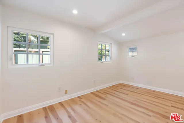 a view of a livingroom with wooden floor and window