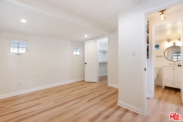 a view of a room with wooden floor and entry gate
