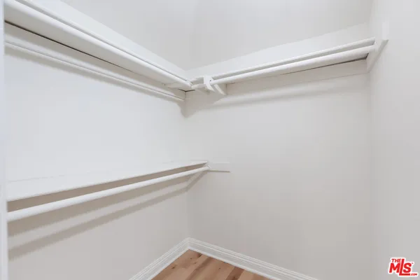 a kitchen with stainless steel appliances a sink a refrigerator and a window