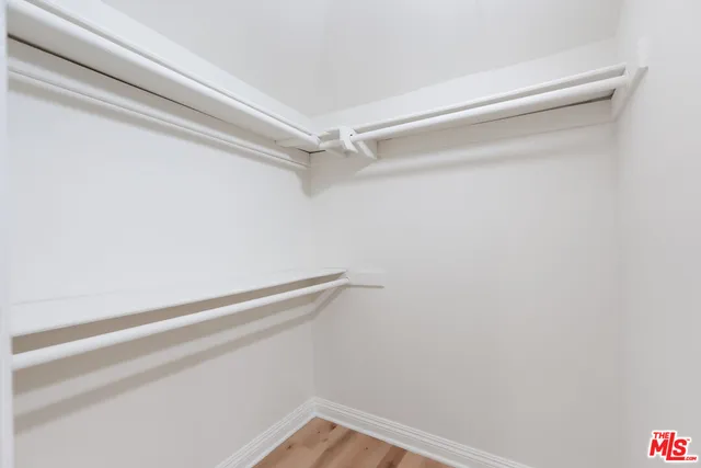 a kitchen with stainless steel appliances a sink a refrigerator and a window