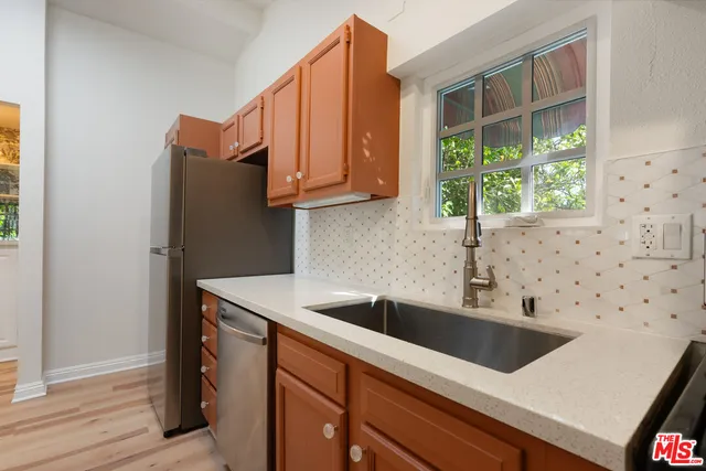a view of a spacious bathroom with a toilet and a chandelier