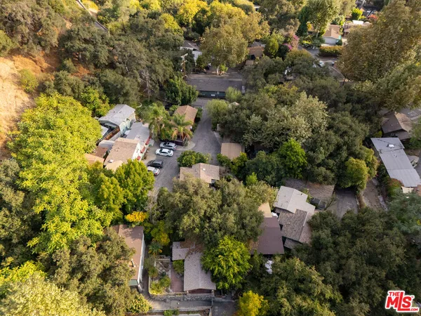 an aerial view of a house with a yard