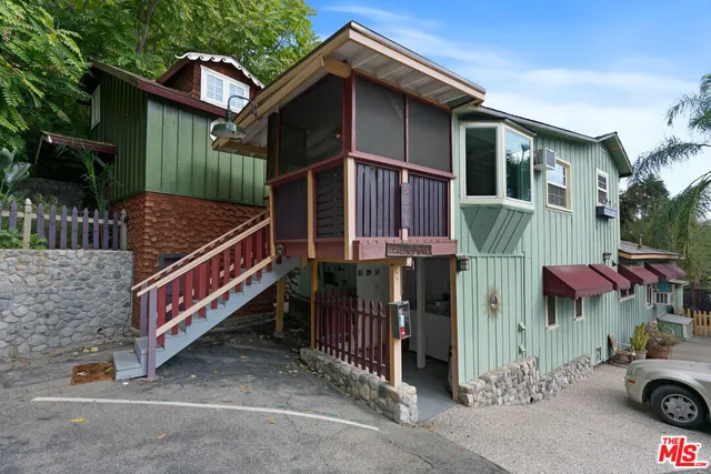 a view of kitchen with wooden floor refrigerator and window