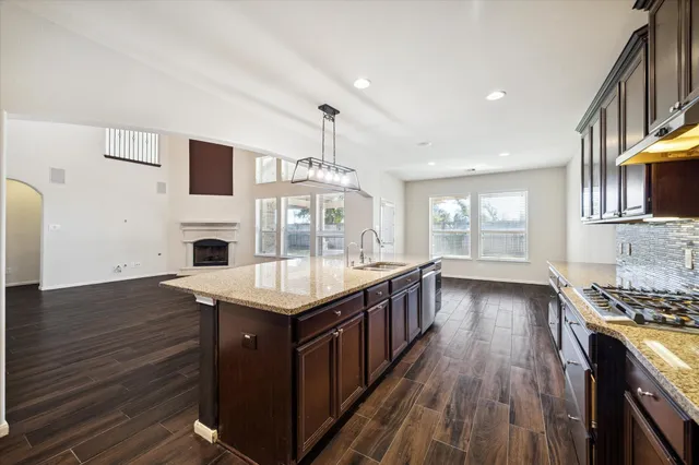 a kitchen with sink stove and refrigerator