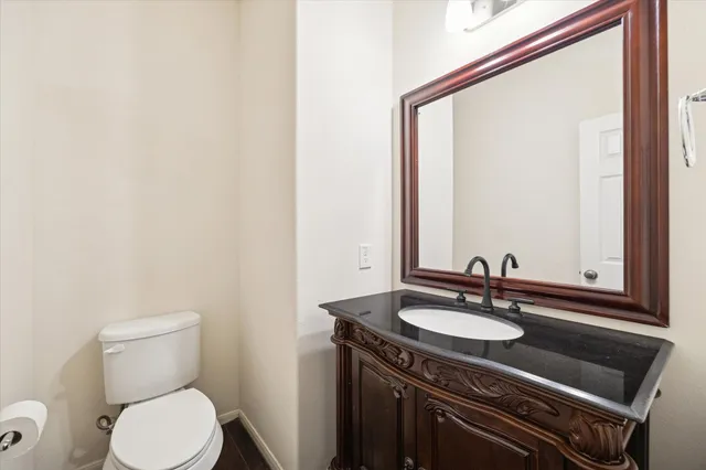 a bathroom with a sink a toilet and mirror