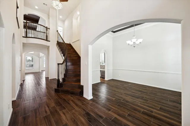 a view of entryway and hall with wooden floor
