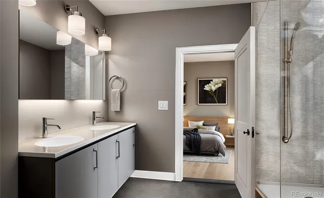 a en suite bathroom with a double vanity sink and a mirror