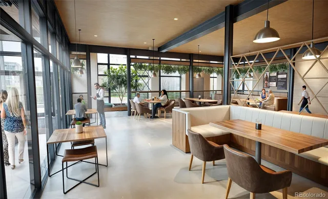 a dining room with furniture and large windows