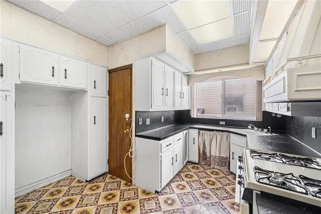 a kitchen with a stove and a refrigerator