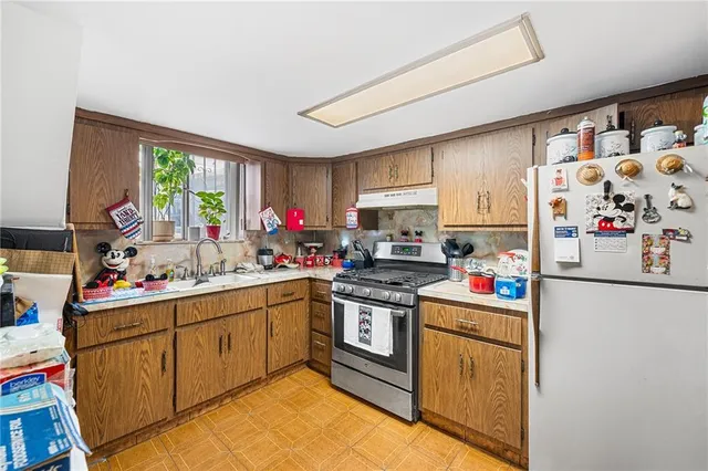 a view of a dining room with furniture and a kitchen