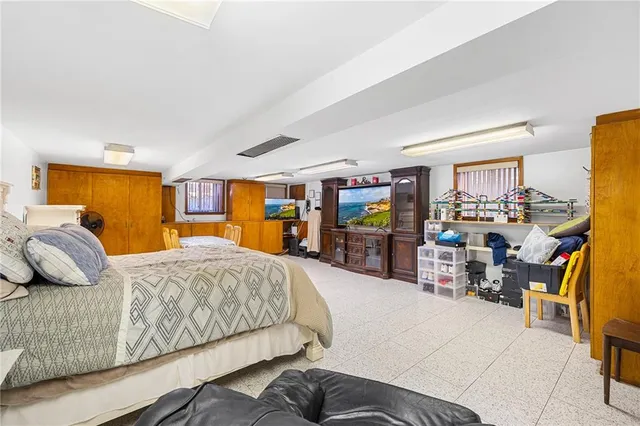 a bedroom with furniture and a large window
