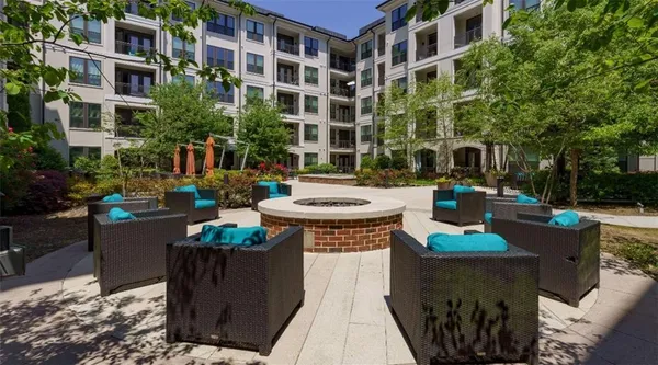 a view of a patio with couches table and chairs and potted plants