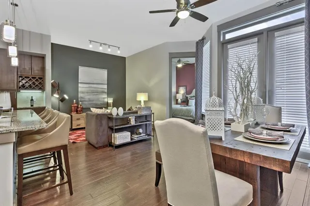 a living room with furniture and wooden floor