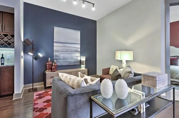 a living room with furniture and wooden floor