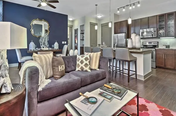a living room with furniture and kitchen view