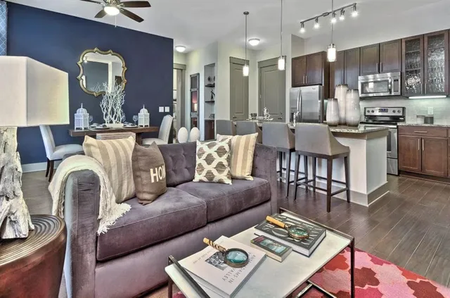a living room with furniture and kitchen view