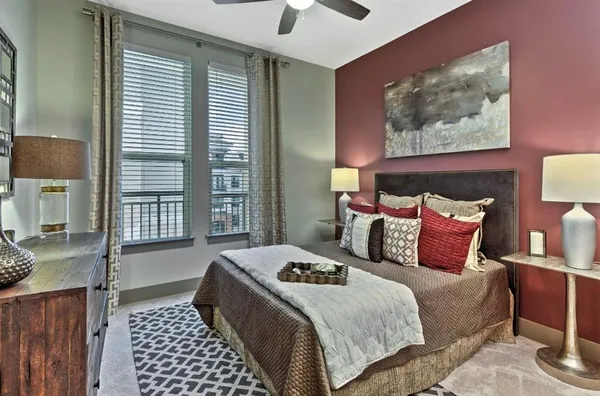 a bedroom with a large bed and a window