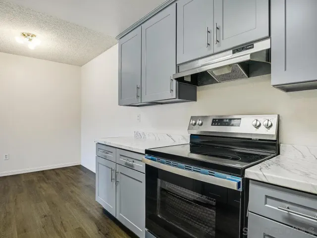 a stove top oven sitting inside of a kitchen