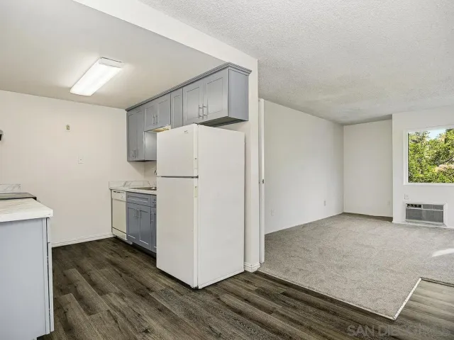 a kitchen with a refrigerator sink and cabinets