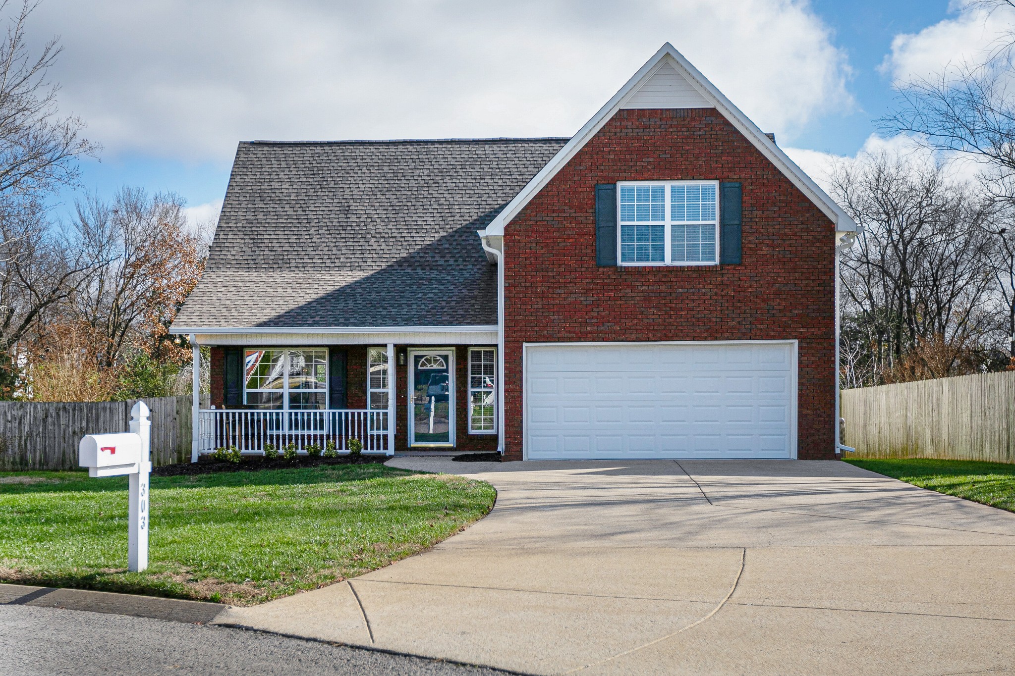 303 Cheairs Court Spring Hill, TN 37174 - Photo 1 of 23 a front view of a house with a yard and garage