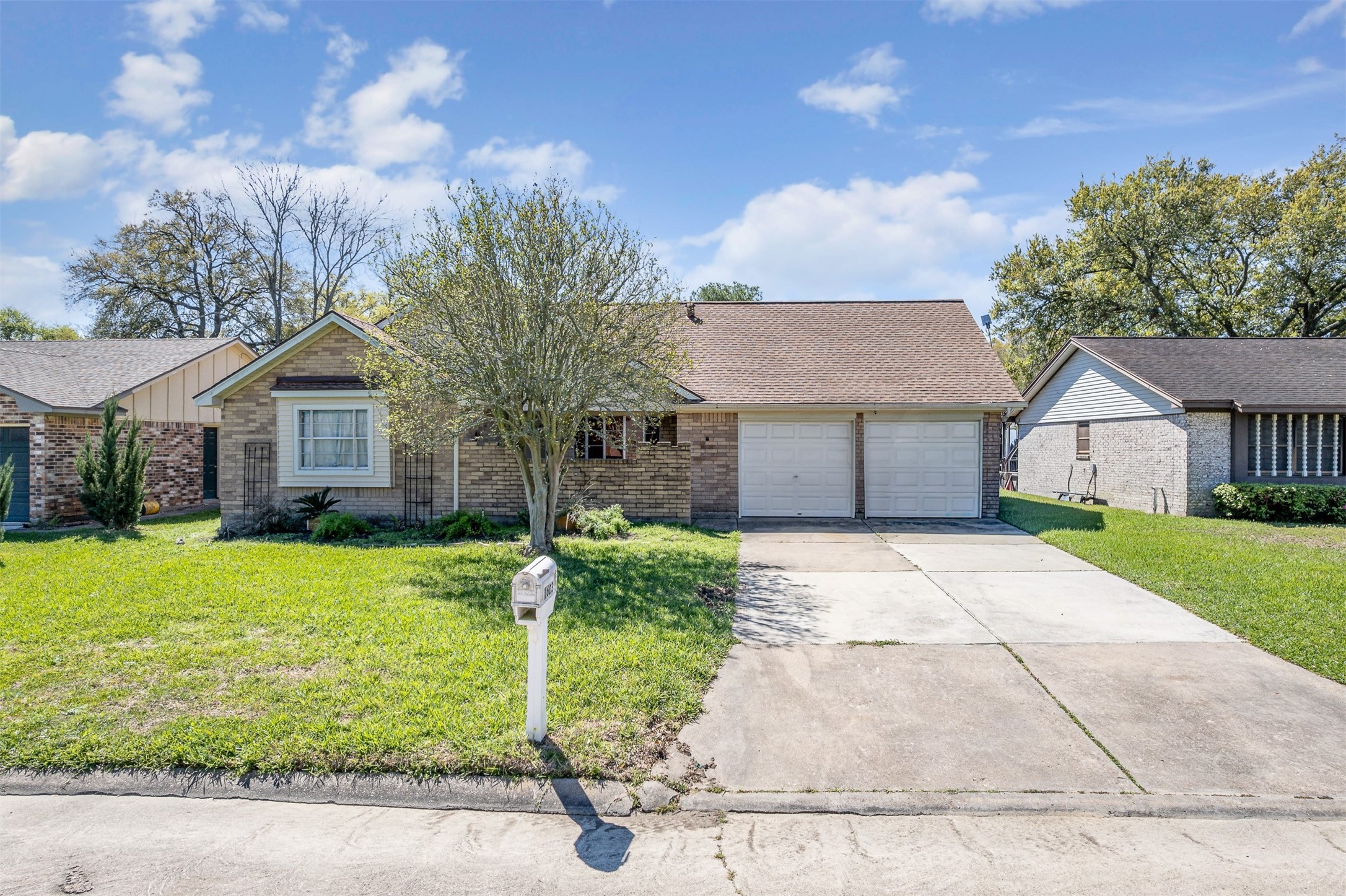 1603 East Baker Road Baytown, TX 77521 - Photo 1 of 26 Charming single-story brick home with an attached two-car garage and a spacious driveway.