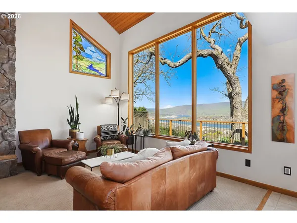 a living room with furniture city view and large windows