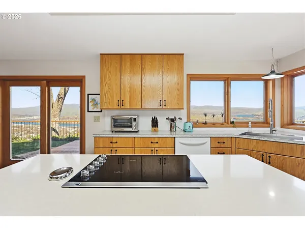 a large white kitchen with a large window