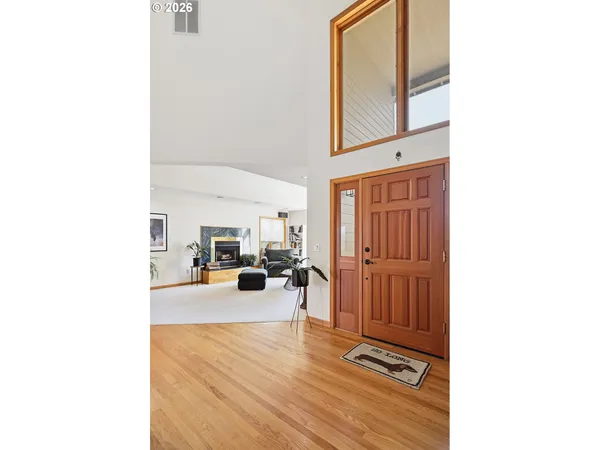 a view of a living room with a chair and dining table