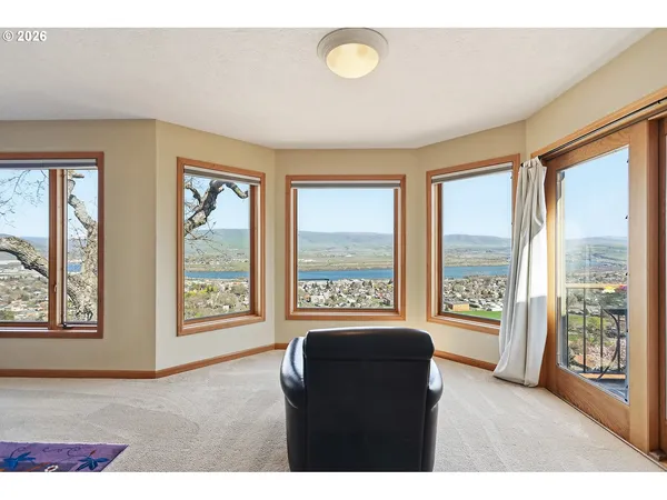a living room with furniture and a floor to ceiling window