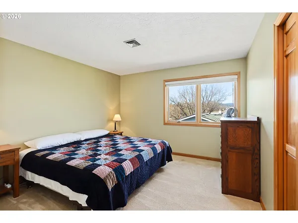 a bedroom with furniture and a window