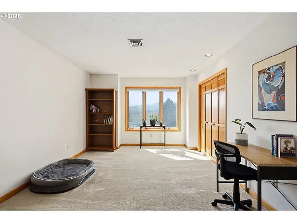 a view of a livingroom with furniture and a window