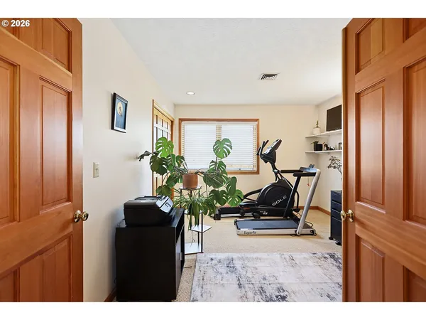 a work room with furniture and a flat screen tv