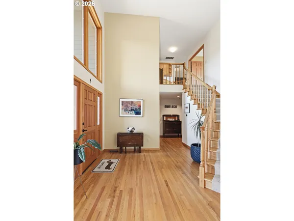a view of a living room with furniture and a wooden floor