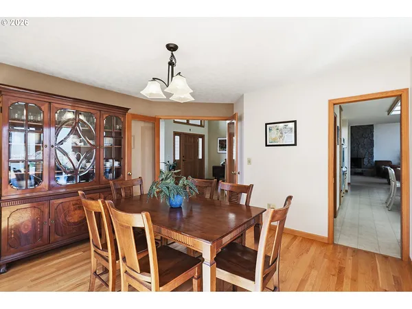 a view of a dining room with furniture wooden floor and chandelier